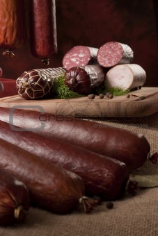 A composition of different sorts of sausages on dark background