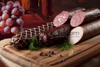 A composition of different sorts of sausages on dark background