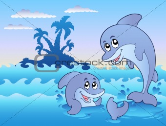 Two dolphins playing in waves