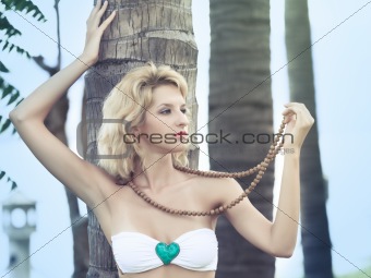 Woman near trunk of palmtree