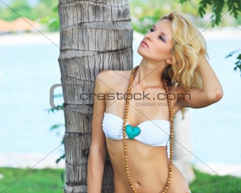 Woman near trunk of palmtree