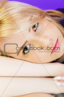 Attractive blond girl against colourful background