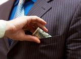 Man putting money into businessman side pocket