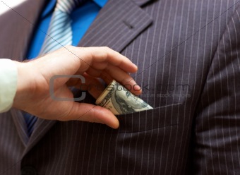 Man putting money into businessman side pocket