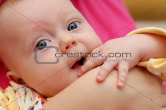 Little 4-month boy on mama's hands