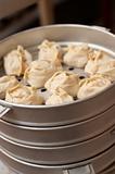 Oriental metall steam cooker with dumplings (manty)