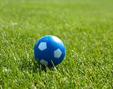 Small blue soccer ball against goal in background