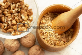 Walnuts: full, cracked and grinded. Focus on masher.