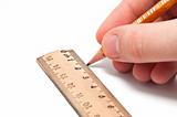 Hand draws a line with a pencil and ruler