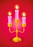 gold candlestick with three burning candle