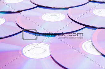 Many DVD's arranged at the white background