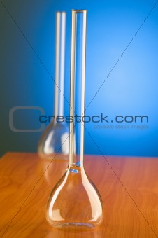 Glass retorts against blue gradient background
