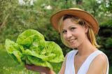 Young woman holding fresh lettuce