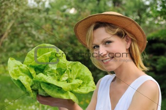 Young woman holding fresh lettuce