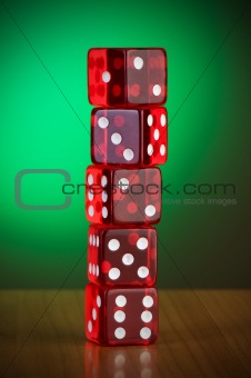 Stack of red casino dice against gradient background