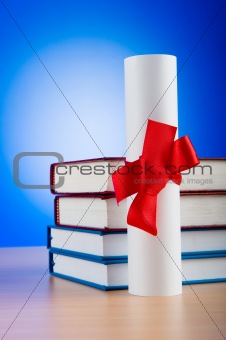 Diploma and stack of books against the background