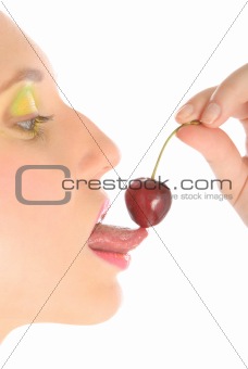 Woman with make-up licks cherry