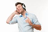 man in blue shirt with earphones listening to music - isolated on gray