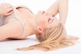 beautiful young woman lying down, eyes closed, dreaming - isolated on white