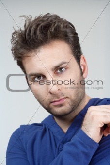 portrait of a man in blue top looking - isolated on gray