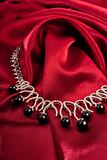 Black pearls on red textile