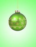 Green christmas ball with ribbon on green background with copy s