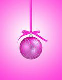 Pink christmas ball with ribbon on pink background with copy spa