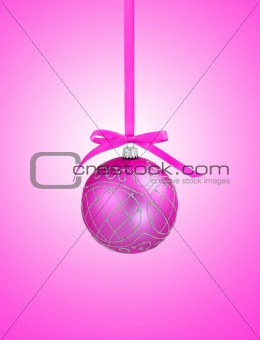 Pink christmas ball with ribbon on pink background with copy spa