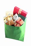 Christmas shopping bag with colorful gift boxes isolated on whit