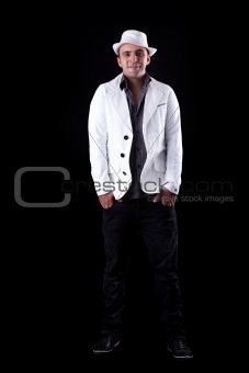 Portrait of a happy man with his white hat and coat, isolated on black. Studio shot