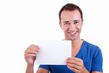 Man holding a white card, smiling and looking to camera, isolated on a white background. Studio shot.