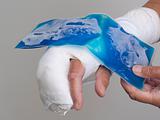 Ice pack being held on hand in cast