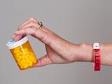 Hand holding container of pills for allergy
