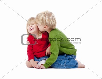 two young siblings fooling around with each other - isolated on white