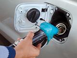 Hand holding blue fuel pump