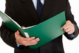 Businessman holding folder with documents in  hand. Close-up.
