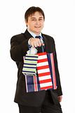 Smiling young businessman giving shopping bags
