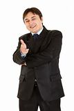 Cheerful young businessman with gun shaped hand
