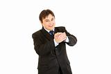 Smiling young businessman cheerfully applauding

