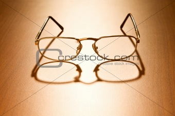 Reading glasses on the wooden table