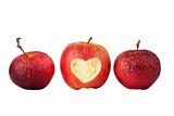 Apple with a heart symbol and two old apples