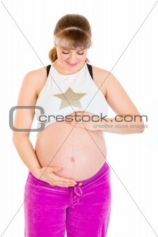 Pregnant female in sportswear holding her belly

