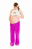 Pregnant woman in sportswear holding her belly
