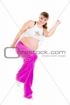 Smiling beautiful pregnant woman doing fitness exercises

