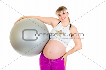 Smiling beautiful pregnant woman  in sportswear holding fitness ball 
