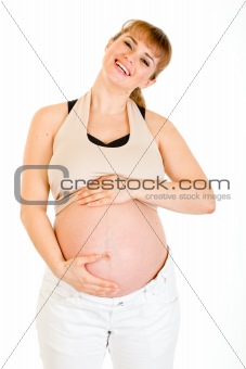 Happy beautiful pregnant woman touching her belly isolated on white
