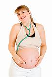 Happy pregnant woman holding stethascope on her belly
