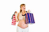 Happy pregnant woman holding shopping bags in hands
