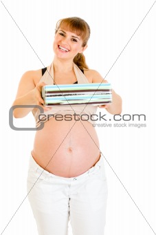 Smiling pregnant woman holding present for her baby 
