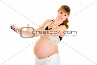 Pregnant woman saying no to tablets.
